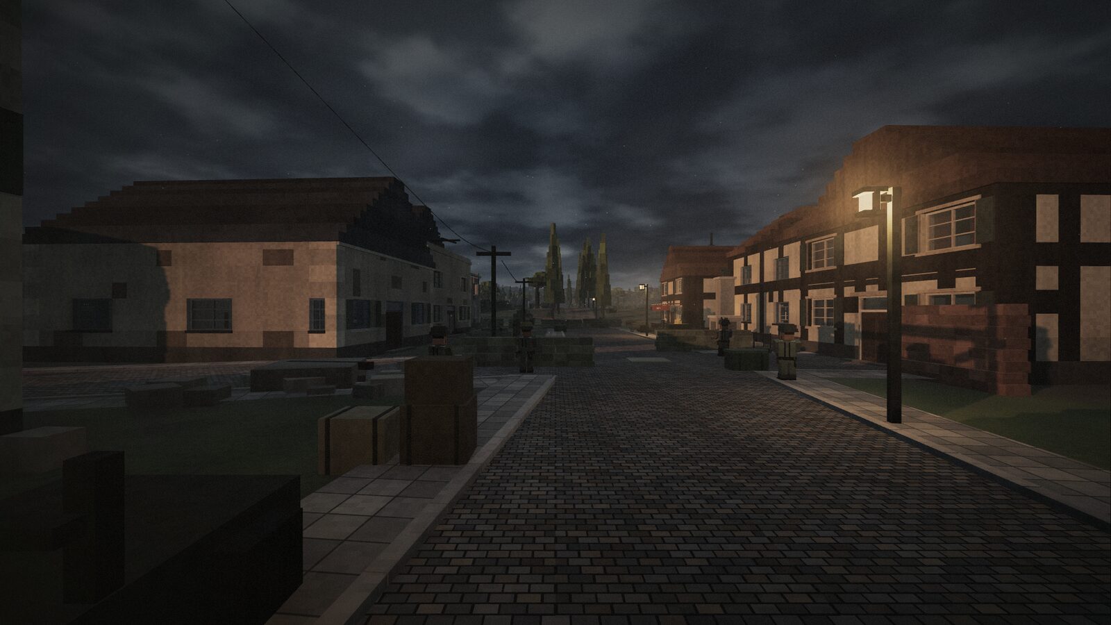 The war memorial by the crossroads at dusk, a patrol in the street behind it.
